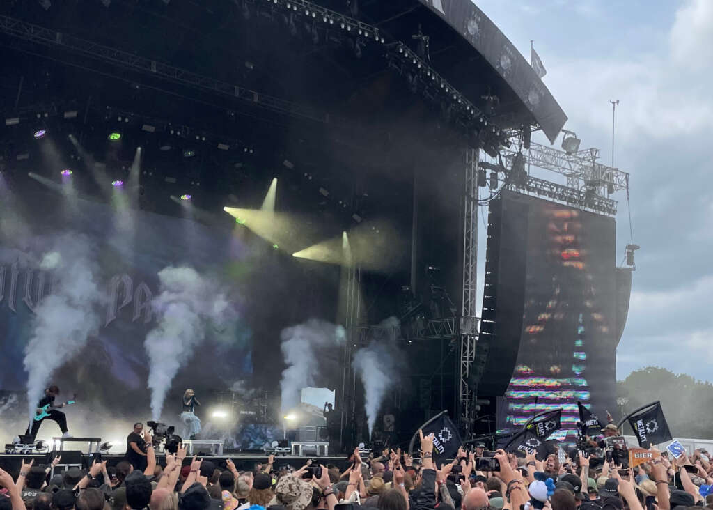 A wheelchair user crowdsurfs toward the "Harder" stage at Wacken Open Air 2026 as Future Palace plays.